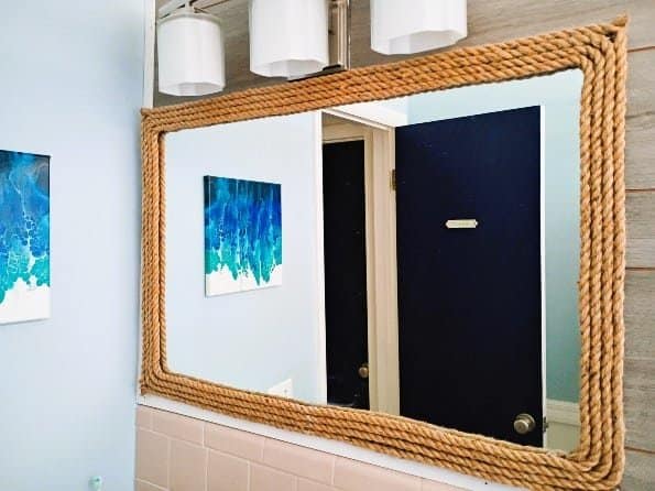 I spent under $35 to make this DIY nautical rope mirror decor for one of my bathrooms. And besides already having the mirror to do this - the project was super easy. Finding the twine rope was difficult, mainly because I was picky - I wanted a thick, distressed and natural looking twine (not some poly-blend type rope, which is all I was finding).